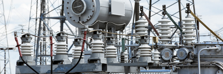 Electric power transmission lines. High voltage switchgear and equipment in front of power plant.の写真素材