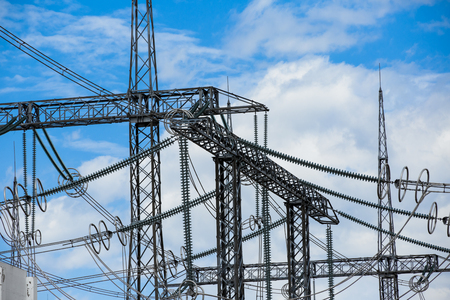 Electric power transmission lines. High voltage switchgear and equipment in front of power plant.の写真素材