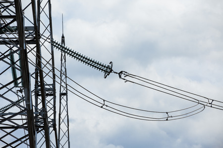 Electric power transmission lines. High voltage switchgear and equipment in front of power plant.の写真素材