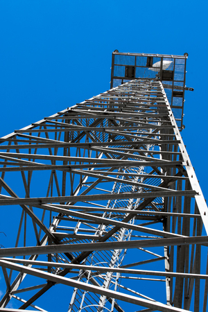 Electric power transmission lines. High voltage switchgear and equipment in front of power plant.の写真素材