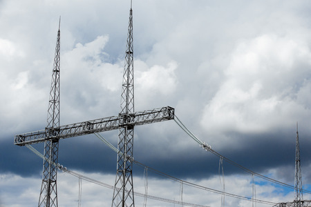 Electric power transmission lines. High voltage switchgear and equipment in front of power plant.の写真素材
