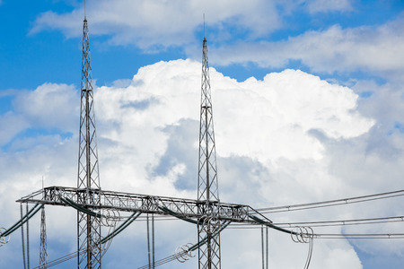 Electric power transmission lines. High voltage switchgear and equipment in front of power plant.の写真素材