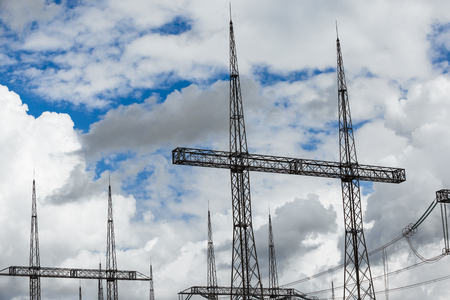 Electric power transmission lines. High voltage switchgear and equipment in front of power plant.の写真素材