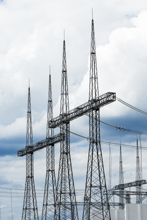 Electric power transmission lines. High voltage switchgear and equipment in front of power plant.の写真素材