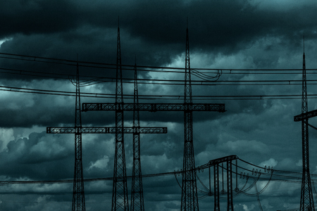 Electric power transmission lines. High voltage switchgear and equipment in front of power plant.の写真素材