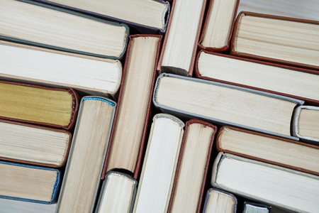 Chaotic stack of old books pastel colors, selective focus with copy spaceの写真素材