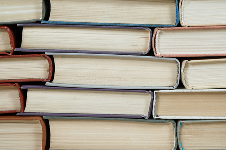 Chaotic stack of old books pastel colors, selective focus with copy spaceの写真素材