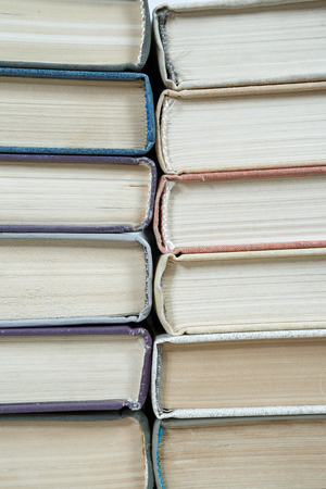 Chaotic stack of old books pastel colors, selective focus with copy spaceの写真素材