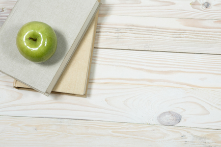 Stack of books and apple on the table. Copy space for text. Selective focus. Knowledge conceptの写真素材