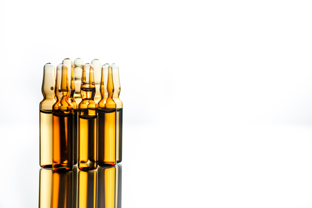 Group object of liquid medicinal agent in limpid glassware in medical laboratory. Group of ampoules with a transparent medicine in medical laboratoryの写真素材