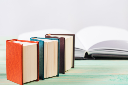 Pile of miniature books on wooden background. With copy space for your textの写真素材