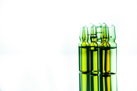 Group object of liquid medicinal agent in limpid glassware in medical laboratory. Group of ampoules with a transparent medicine in medical laboratoryの写真素材