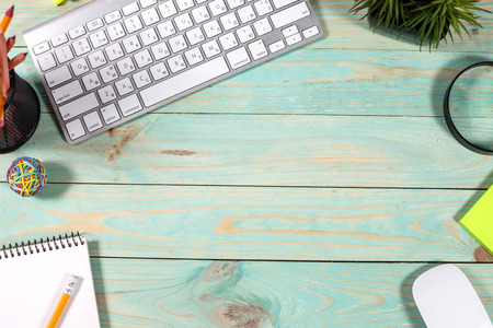 Modern green wooden office desk with laptop computer. Minimal concept. Top view with copy space, flat lay. Workspace creative designerの写真素材