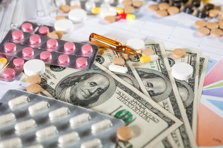 Medical marketing and healthcare business analysis report with graph and many. Pile of pills in blister packs backgroundの写真素材