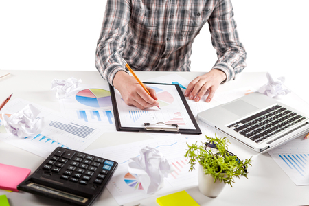 Businessman holding a pen is working with graph documents. Stock market chart and finger pointing on tablet in office.の写真素材