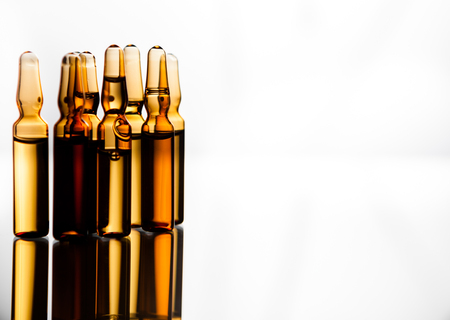 Group object of liquid medicinal agent in limpid glassware in medical laboratory. Group of ampoules with a transparent medicine in medical laboratoryの写真素材