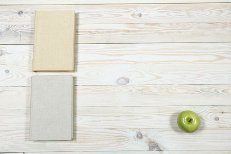 Stack of books and apple on the table. Copy space for text. Selective focus. Knowledge conceptの写真素材