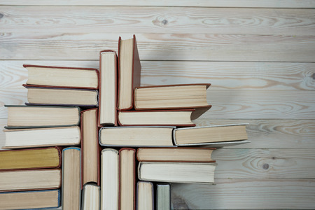 Chaotic stack of old books pastel colors, selective focus with copy spaceの写真素材