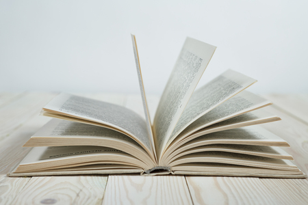 Open of pastel colorsbooks hardback on wooden table. Copy space. Selective focus. Knowledge conceptの写真素材