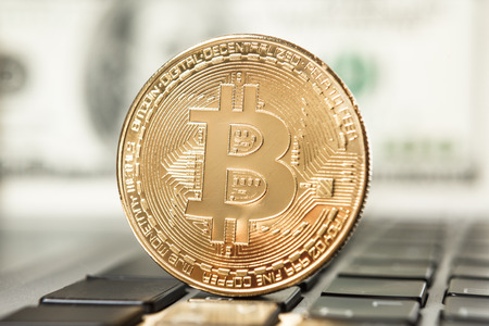 New virtual money Golden bitcoin coin on a black keyboard. Cryptocurrency. Business and Trading concept.の写真素材