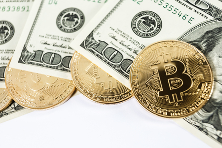 New virtual money Golden bitcoin coin on us dollars background . Cryptocurrency. Business and Trading concept.の写真素材