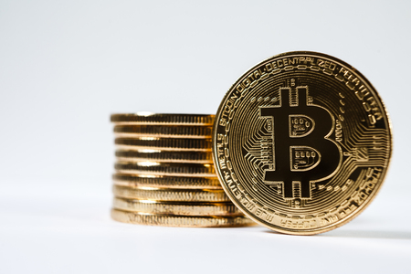 New virtual money Golden bitcoin coin on a white. Cryptocurrency. Business and Trading concept.の写真素材