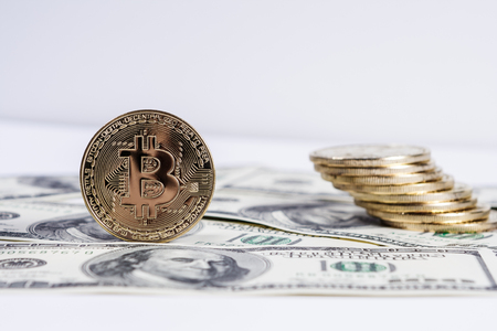New virtual money Golden bitcoin coin on us dollars background . Cryptocurrency. Business and Trading concept.の写真素材