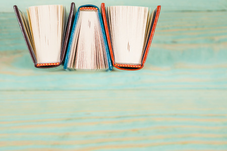 Pile of miniature books on wooden background. With copy space for your textの写真素材