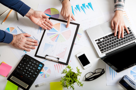 Business people discussing the charts and graphs showing the results of their successful teamwork. Forex Trade Graph Chart Concept. Stock market chart and finger pointing on tablet in office.の写真素材