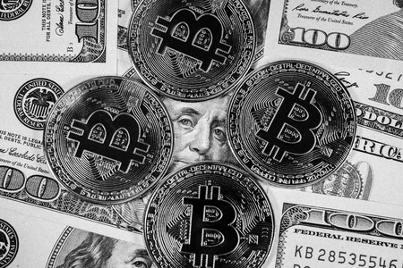 New virtual money Golden bitcoin coin on us dollars background . Cryptocurrency. Business and Trading concept. Close-up shot. black and white imageの写真素材