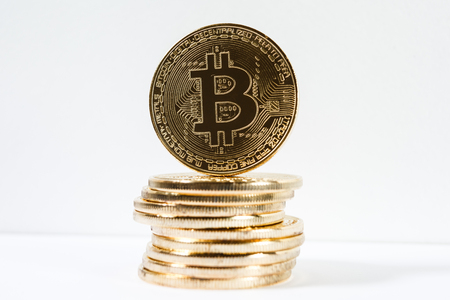 New virtual money Golden bitcoin coin on a white. Cryptocurrency. Business and Trading concept.の写真素材