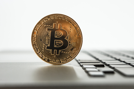 New virtual money Golden bitcoin coin on a black keyboard. Cryptocurrency. Business and Trading concept.の写真素材