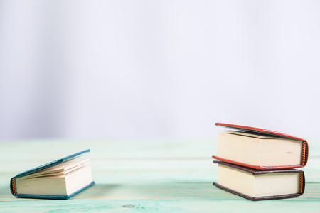 Pile of miniature books on wooden background. With copy space for your textの写真素材