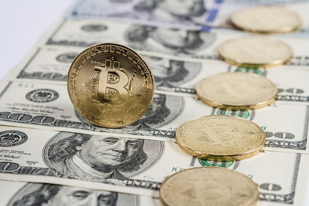 New virtual money Golden bitcoin coin on us dollars background . Cryptocurrency. Business and Trading concept.の写真素材