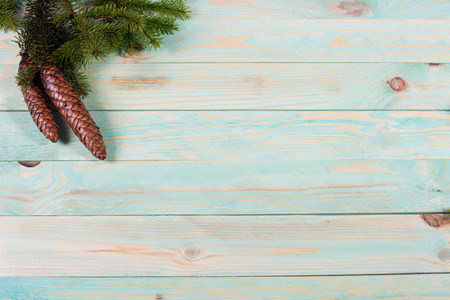 Christmas background with spruce branches on wooden board with copy spaceの写真素材