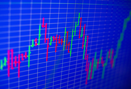 Financial graph on a computer monitor screen. Background stock chart. Analysing stock market data on a monitor. Blue background with stock chart. Finance concept. Tools of technical analysis.の写真素材