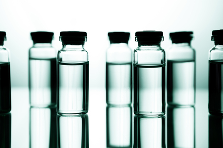 Group object of liquid medicinal agent in limpid glassware in medical laboratory. Group of ampoules with a transparent medicine in medical laboratoryの写真素材