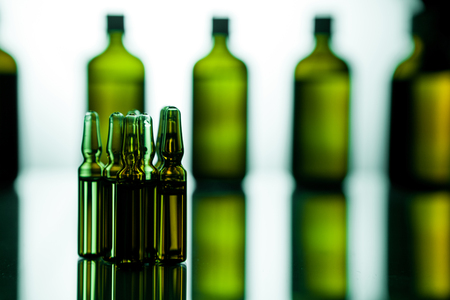 Group object of liquid medicinal agent in limpid glassware in medical laboratory. Group of ampoules with a transparent medicine in medical laboratoryの写真素材