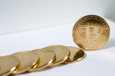 New virtual money Golden bitcoin coin on a white. Cryptocurrency. Business and Trading concept.の写真素材