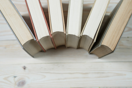 Pile of old pastel colors books stacked. Selective focus with copy spaceの写真素材