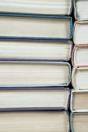 Chaotic stack of old books pastel colors, selective focus with copy spaceの写真素材