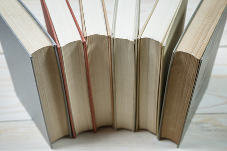 Pile of old pastel colors books stacked. Selective focus with copy spaceの写真素材