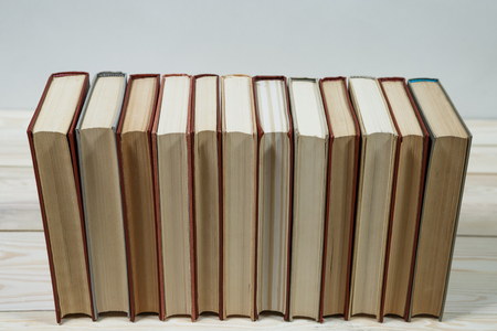 Pile of old pastel colors books stacked. Selective focus with copy spaceの写真素材