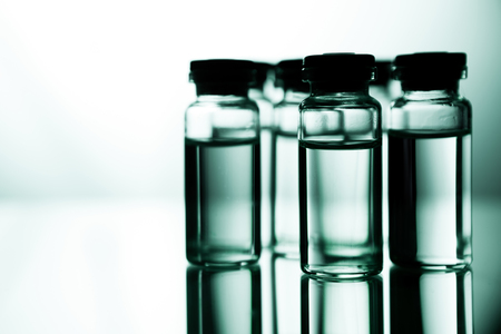 Group object of liquid medicinal agent in limpid glassware in medical laboratory. Group of ampoules with a transparent medicine in medical laboratoryの写真素材