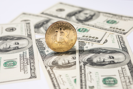 New virtual money Golden bitcoin coin on us dollars background . Cryptocurrency. Business and Trading concept.の写真素材