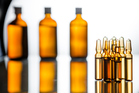 Group object of liquid medicinal agent in limpid glassware in medical laboratory. Group of ampoules with a transparent medicine in medical laboratoryの写真素材