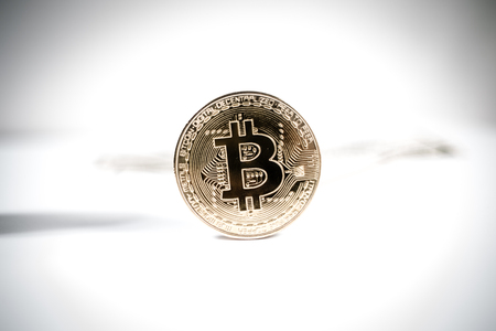 New virtual money Golden bitcoin coin on us dollars background . Cryptocurrency. Business and Trading concept.の写真素材