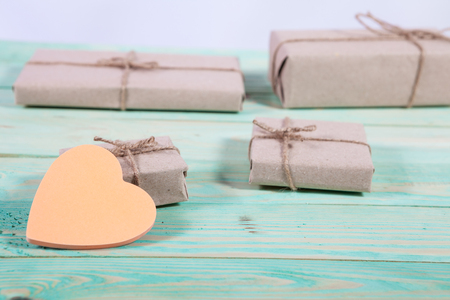 Gift boxes wrapped kraft paper tied with twine and sticker heart and tied with twine. with copy spaceの写真素材