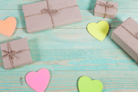 Gift boxes wrapped kraft paper tied with twine and sticker heart and tied with twine. with copy spaceの写真素材