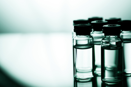Group object of liquid medicinal agent in limpid glassware in medical laboratory. Group of ampoules with a transparent medicine in medical laboratoryの写真素材